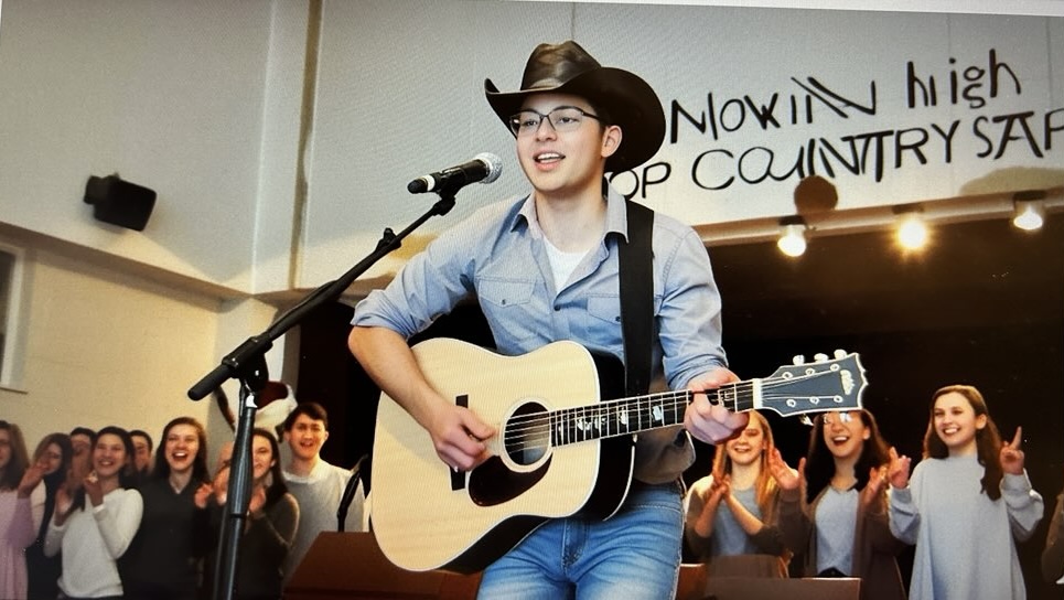 Brent Bryner performs in front of the cafeteria during Lunch C. 