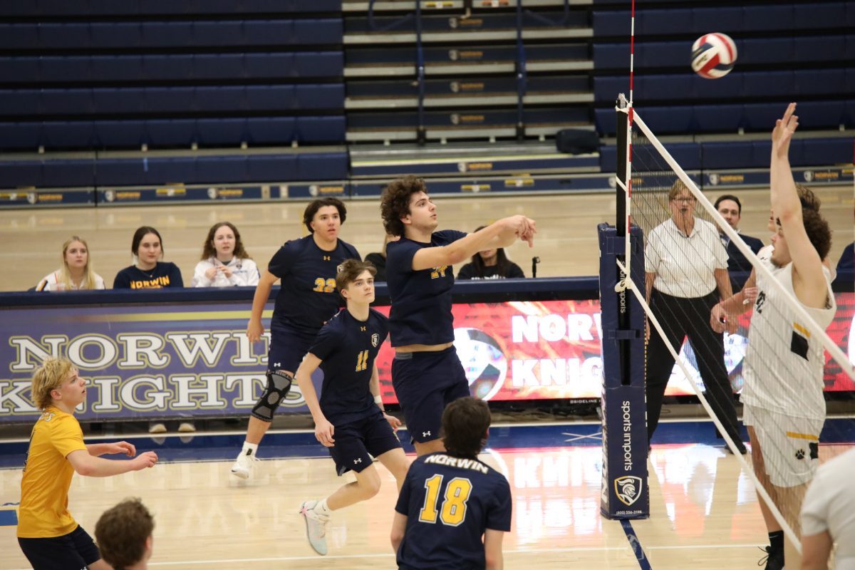 John Olshanski (#24) spikes the ball on the opposing team.