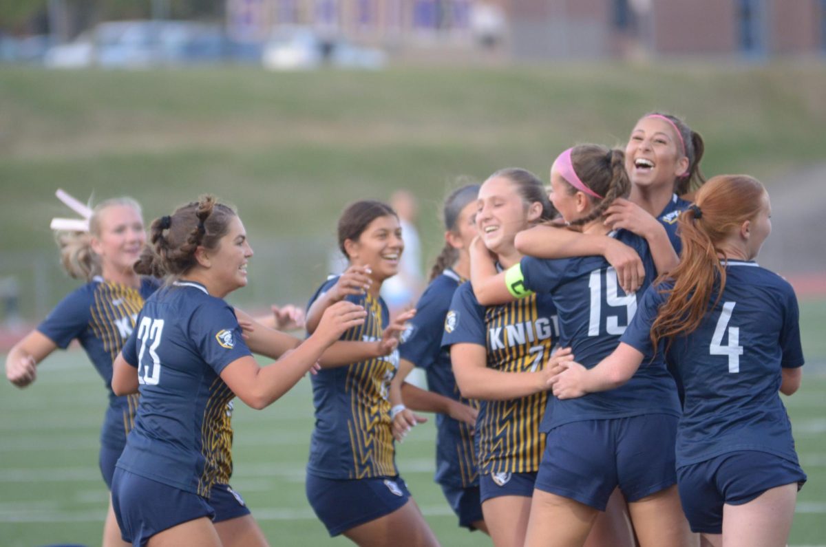 The Lady Knights Celebrate after they score.