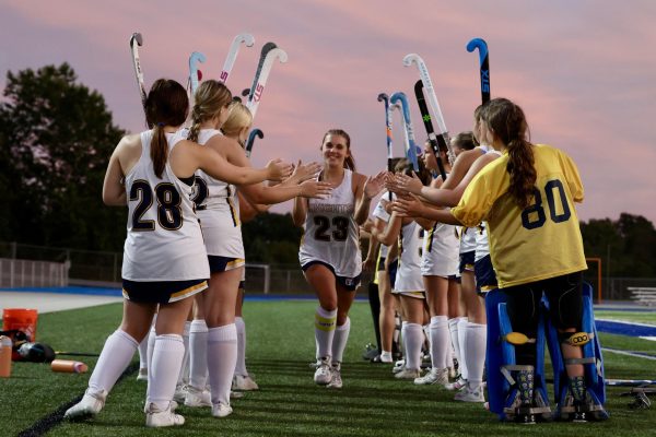 Senior Savannah Gareis(center) celebrating after a game with the rest of the team.