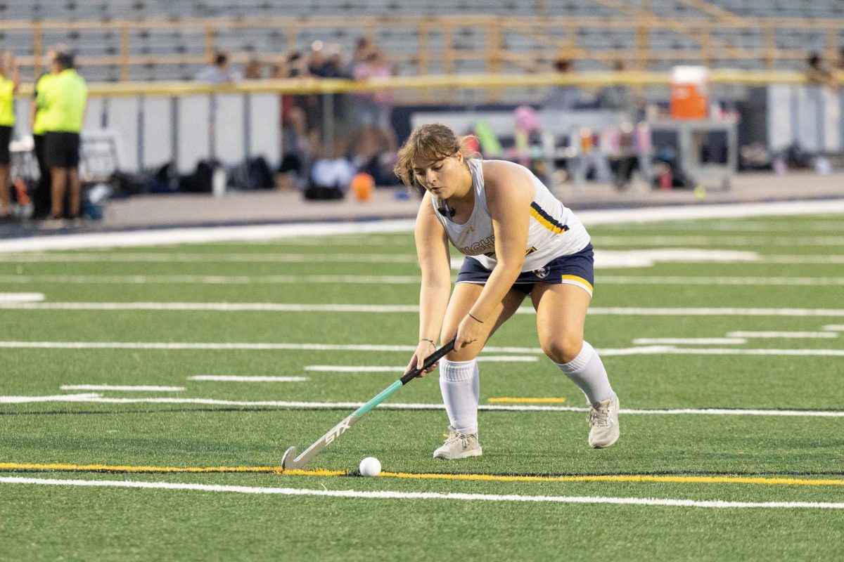Mia Douglas (12) handling the ball in the midst of a game.