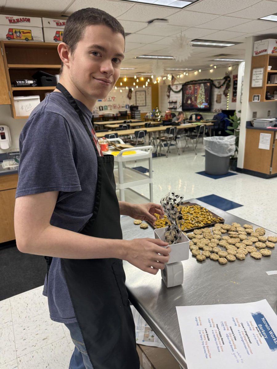 Luke Osborne weighs a bag of treats