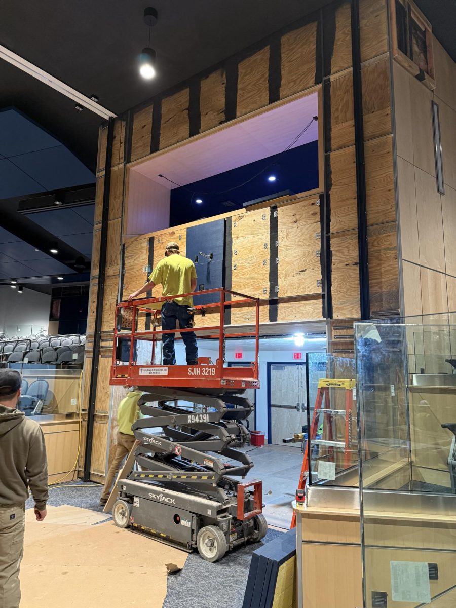 Workers construct the lighting booth