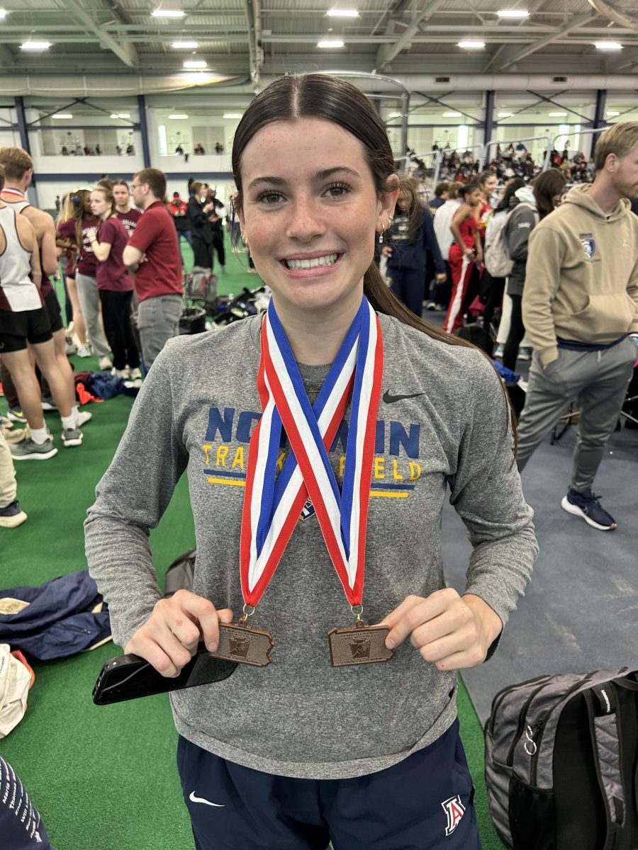 Myla McCabe poses with her two state medals at PTFCA State Championship at Penn State. McCabe medaled in 7th in the 400m and 6th in the Distance Medley Relay.