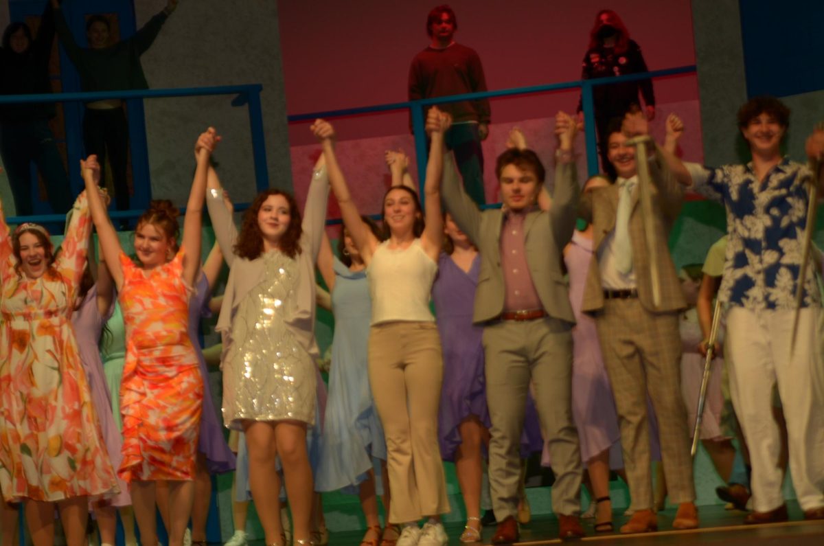 The cast of Mamma Mia bows together after a successful show.
